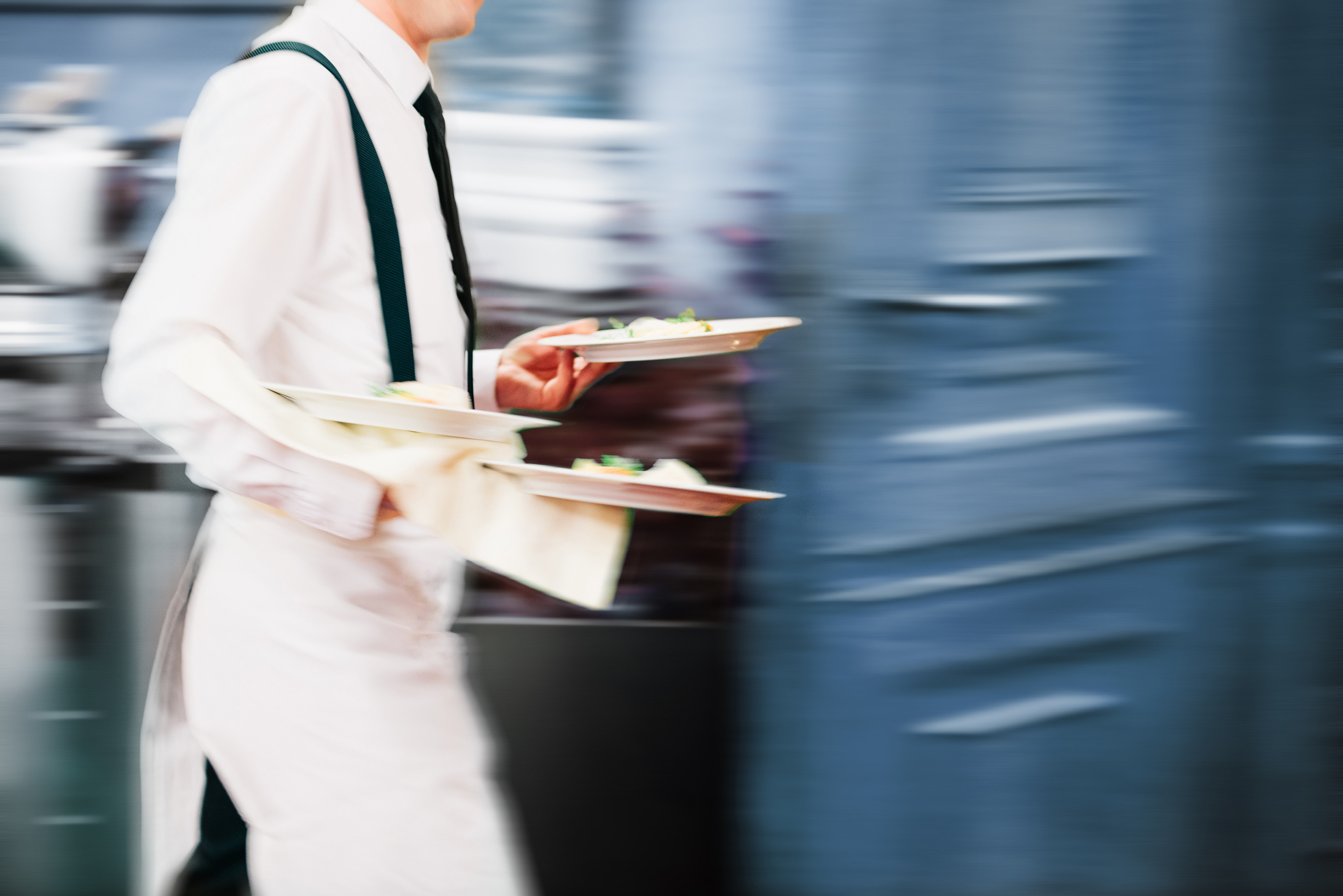 Waiter serving food plates